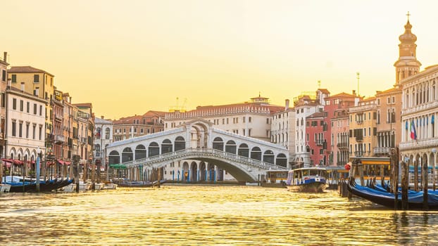 Panoramic view of famous Canal Grande with famous Rialto Bridge at sunset in Venice