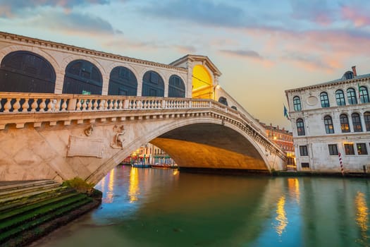 Panoramic view of famous Canal Grande with famous Rialto Bridge at sunset in Venice