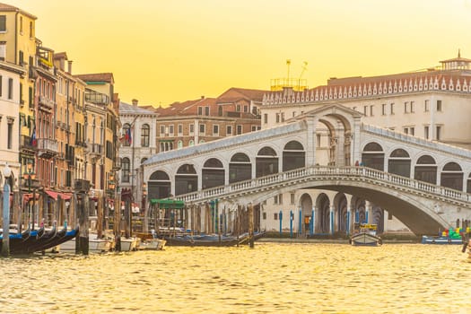 Panoramic view of famous Canal Grande with famous Rialto Bridge at sunset in Venice