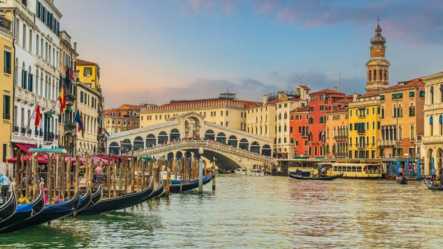 Panoramic view of famous Canal Grande with famous Rialto Bridge at sunset in Venice