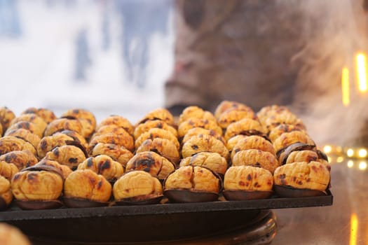 traditional Istanbul street food grilled chestnuts in a row.