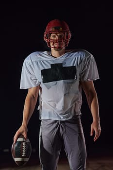 American Football Field: Lonely Athlete Warrior Standing on a Field Holds his Helmet and Ready to Play. Player Preparing to Run, Attack and Score Touchdown