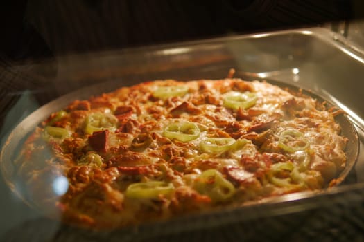 Homemade pizza is baked in a modern electric oven