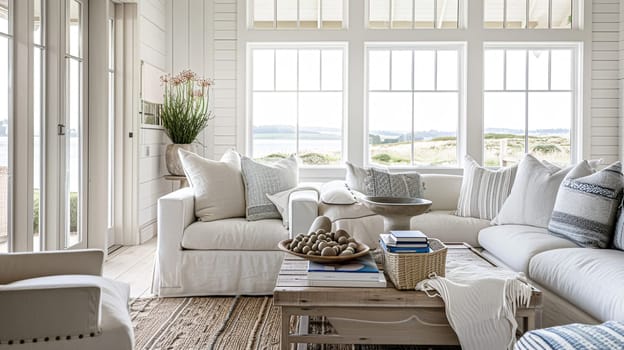 Interior of a living room with white walls, sofa and cushions. Sitting room in coastal cottage with sea view. Luxury lounge room