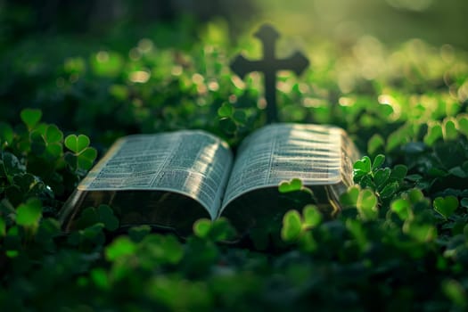 a bible book and a cross lying on the green clover leaves..