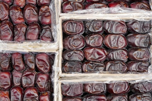 many date fruits display for sale at local market .