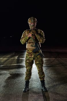 A professional soldier in full military gear striding through the dark night as he embarks on a perilous military mission.