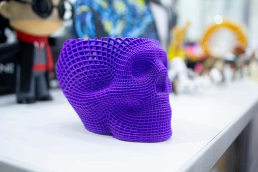 Prototype of human skull printed on 3D printer from molten purple plastic. Modern new printing manufacturing. Additive progressive medical technology. Three-dimensional model skull 3D printed close-up