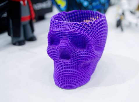 Prototype of human skull printed on 3D printer from molten purple plastic. Modern new printing manufacturing. Additive progressive medical technology. Three-dimensional model skull 3D printed close-up