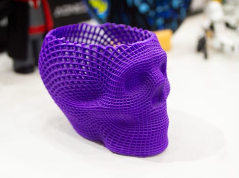 Prototype of human skull printed on 3D printer from molten purple plastic. Modern new printing manufacturing. Additive progressive medical technology. Three-dimensional model skull 3D printed close-up