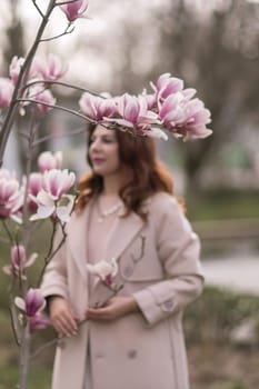 Woman magnolia flowers, surrounded by blossoming trees, hair down, wearing a light coat. Captured during spring, showcasing natural beauty and seasonal change