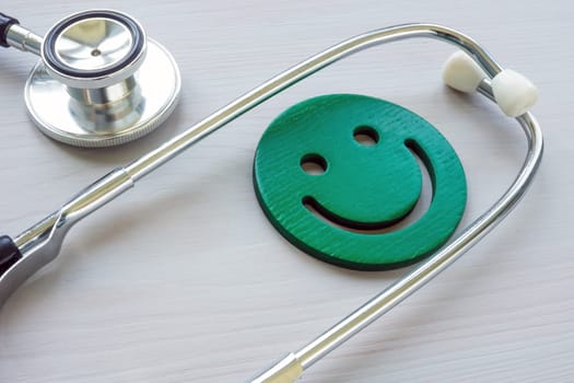 Patient experience or satisfaction concept. Medical stethoscope and smiley face.