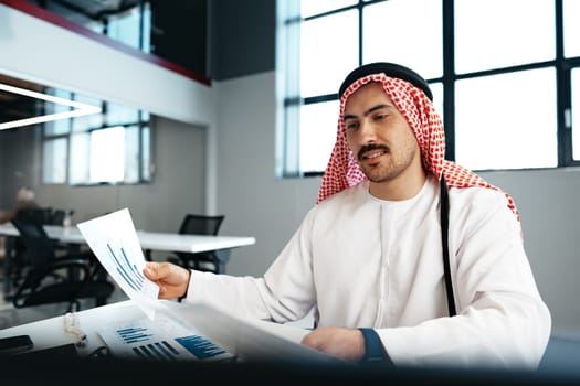 Young successful arab businessman working in the office close up