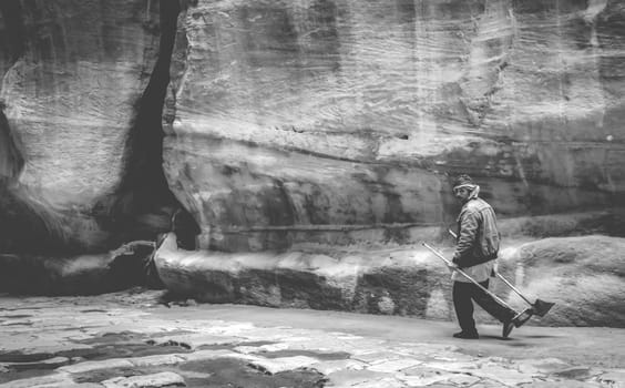 Pertra, Jordan - 29 March 2019: Al-Siq canyon - path to Petra Treasury, Petra, Jordan with person