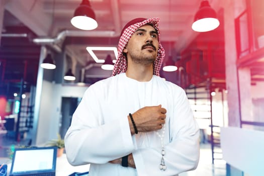 Successful muslim businessmen in traditional outfit in his office, portrait