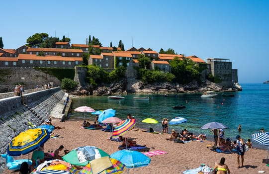 Budva, Montenegro - 27 July 2021: Beach in Sveti Stefan island in Budva, Montenegro in sunny day. Luxury resort in Adriatic sea