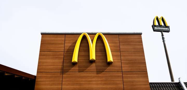 Berlin, Germany - 10 April 2023: big sign and sign board on entrance of McDonald's