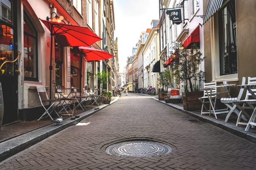 Hague, Netherland - 09 April 2023: Cozy Cafe on a street of Hague in Holland. Summer tourist place whith attractions and shops.