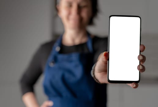 Woman In Stylish Forefront Shows Smartphone With White Screen In Close-Up View