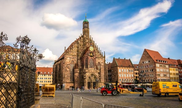 Nurnberg, Germany - 29 August 2022: Old city center with Church of the Virgin Mary in Nuremberg. Historical square in Bavaria region, Europe with beautiful houses and blue sky