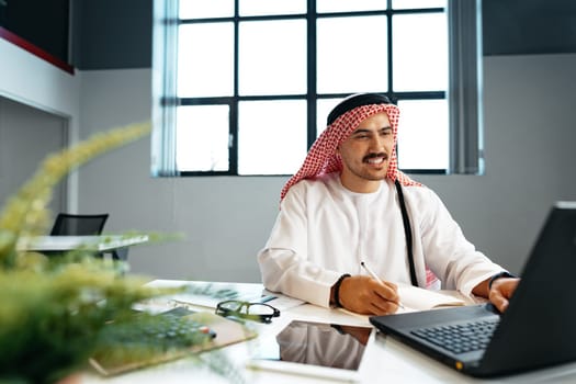 Young successful arab businessman working in the office close up