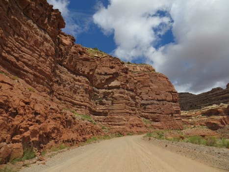 Single Lane Dirt Road by Red Rock Cliffs, Moki Dugway in Utah, Highway 261. High quality photo