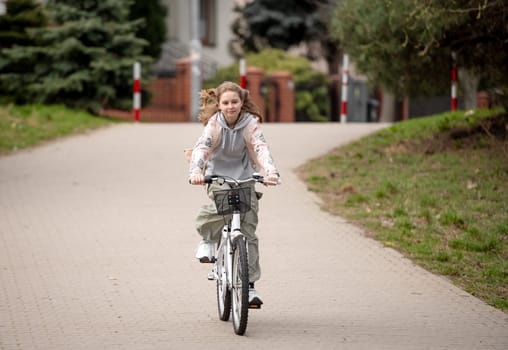 Girl Rides Bicycle On Pedestrian Road In Warm Spring Weather