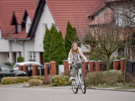 Girl Rides Bicycle Among Private Houses In Europe During Spring