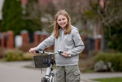Girl Rides Bicycle Among Private Houses In Europe During Spring