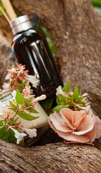 Spa set decorated with natural white jazmine and pink fabric flowers. Rustic trunk