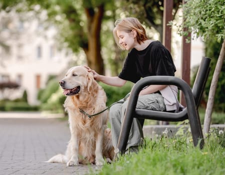 Summer Finds Girl With Golden Retriever Sitting On Bench