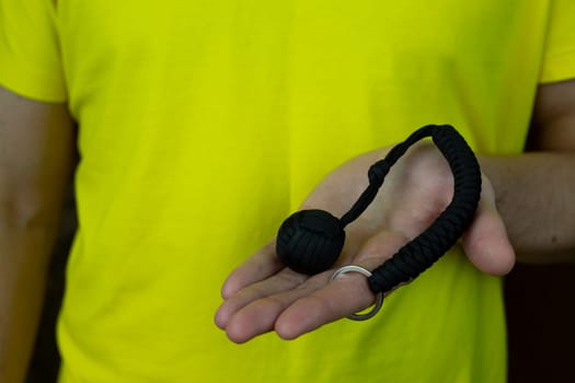 Compact baton for self-defense, keychain made of paracord and metal ball