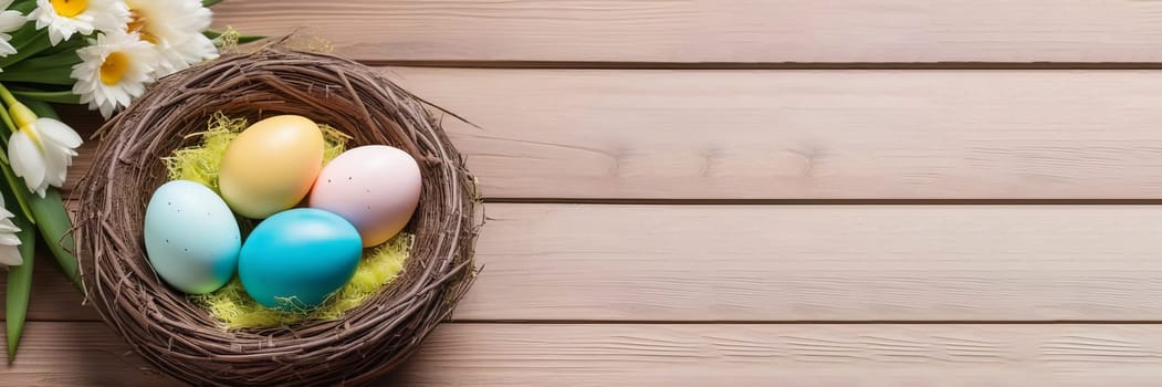 Nest with colorful Easter eggs and flowers on wooden background.