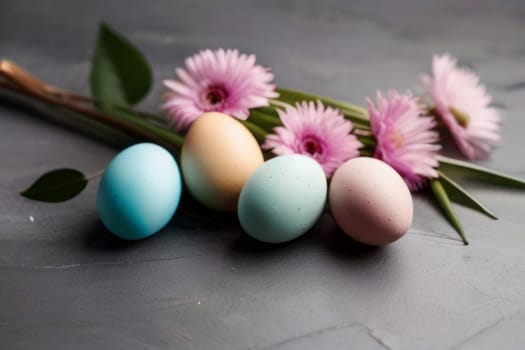 Colorful Easter eggs and blooming flowers on light gray background