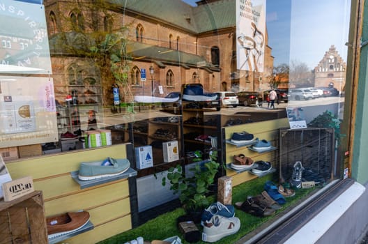 Showcase window of a shoe store in the city of Ystad, Sweden - May 25, 2024.