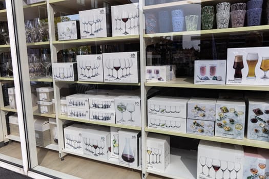 Shop with various tableware glasses and wine glasses in boxes. Denmark - May 25, 2024