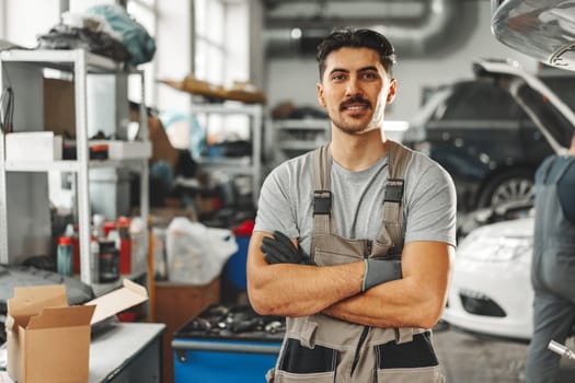 Portrait of a male mechanic in an auto repair shop close up