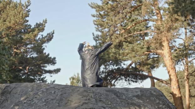 Young man runs and falls off cliff. Stock. Man runs on stone ledge and falls into cliff in forest. Man falls from stone cliff in forest with run.