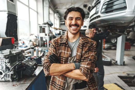 Portrait of a male mechanic in an auto repair shop close up