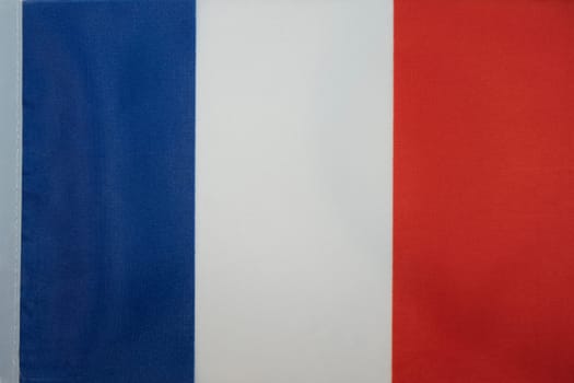 Simple Flag of France. French simple tricolor cloth fabric texture flag. Blue, white and red. Marianne. High quality photo