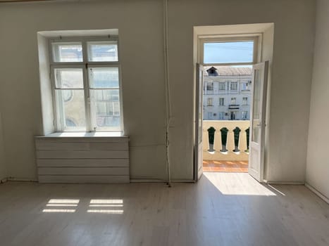 Interior of an empty white room with a window