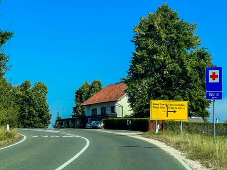 Han Kola, Bosnia and Herzegovina, August 23, 2023: Signpost on the road in the village, towards Banja Luka and Krupa na Vrbasu and hospital sign