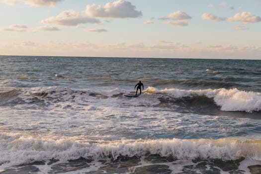 Athletes riding a surfboard on the sea