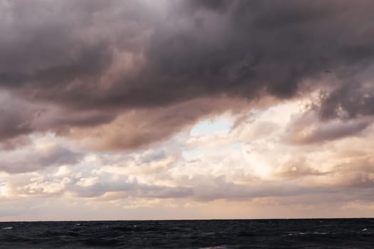 landscape storm on sea and sunset with clouds