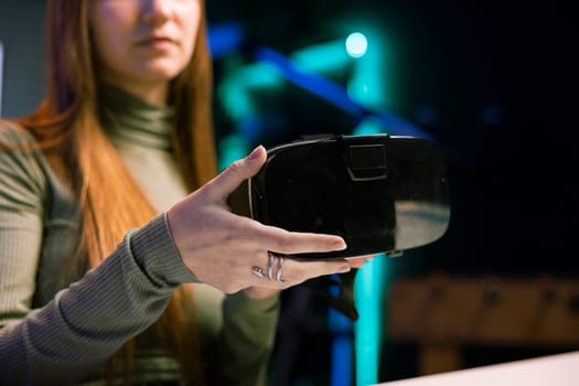 Gen Z tech content creator filming technology review of newly released VR goggles, unboxing them and presenting specifications to audience. Influencer showing virtual reality device to fans, close up