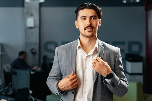 Confident Arab businessman in formal clothes standing in office, portrait