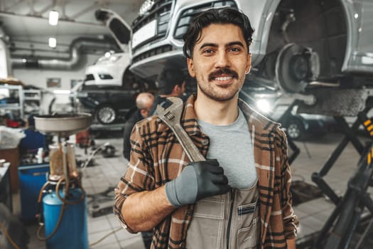 Portrait of a male mechanic in an auto repair shop close up