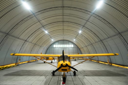 Yellow airplane glider in the hangar