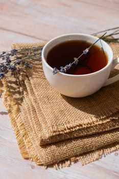 White cup of lavender tea. Mortars of dry lavender alternative medicine. Immunity boosting healthy herbal tea. Lavender flowers.
