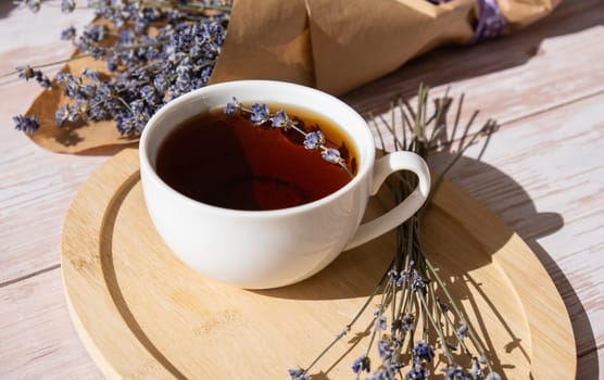 Healthy homemade cup of lavender tea. Organic natural home grown herb for teas. White cup of tea with dried lavender flowers. Healthy living wellbeing self care